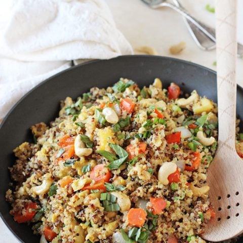 Healthy and easy pineapple cashew quinoa fried rice! Sweet, savory and packed with protein from the quinoa! On the table in about 30 minutes!