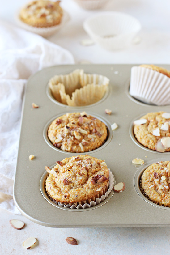A muffin tin filled with baked Orange Olive Oil Muffins.