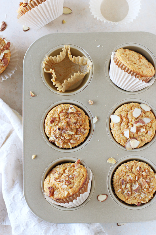 Overhead view of a muffin tin filled with baked Orange Carrot Muffins.