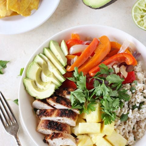 Tropical & bright caribbean chicken bowls! This recipe is filled with creamy coconut rice, crisp colorful veggies and juicy citrus chicken!