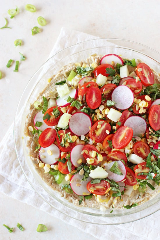 A glass pie dish filled with Veggie Hummus. 