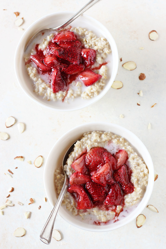 Two bowls of Strawberry Steel Cut Oatmeal with spoons in the bowls.