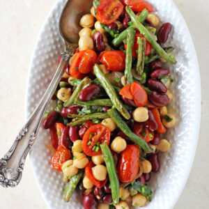 A simple & satisfying three bean salad! Filled with roasted green beans and tomatoes! Finished with fresh herbs and a delightful honey mustard dressing!