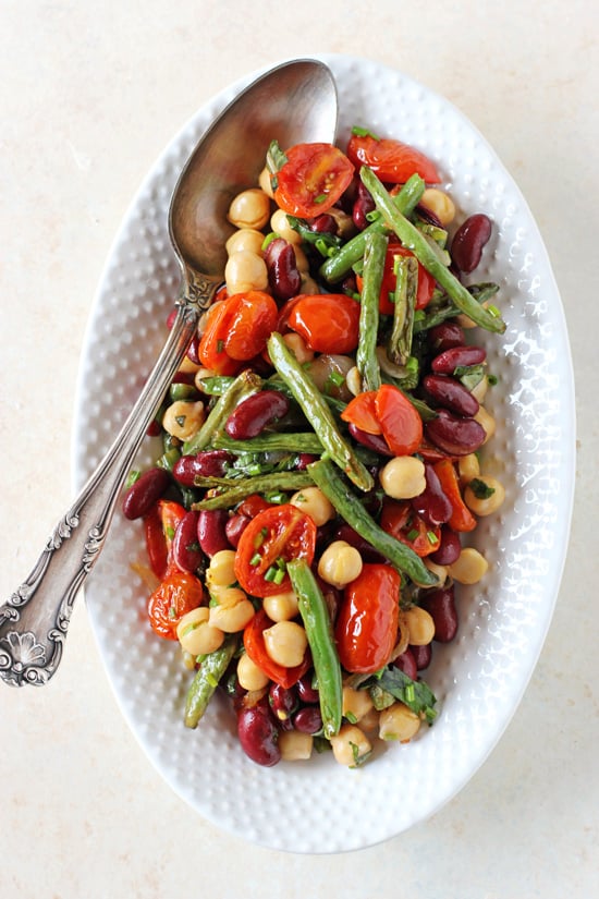 A white serving platter filled with Roasted Three Bean Salad.