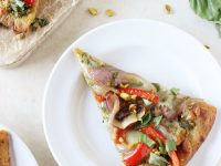 Quick and flavorful veggie and pesto flatbread pizza! With colorful veggies, a pistachio pesto and naan bread! So fun for Spring and Summer!