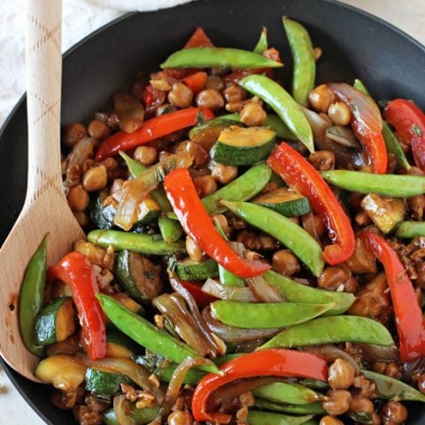 A simple, 30-minute bell pepper, snap pea and zucchini stir-fry that is perfect for summer! Filled with walnuts, basil and so much healthier than take-out!