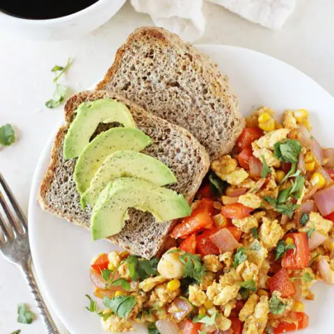 This 20-minute, healthy southwest egg scramble is a simple breakfast or dinner! Filled with bell pepper, fresh corn and plenty of spices!