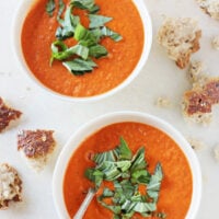 A creamy, healthy and homemade roasted cherry tomato soup! Serve topped with fresh basil and plenty of crusty bread!