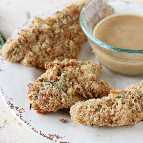 Healthy and juicy baked rosemary walnut chicken tenders! With a walnut & fresh rosemary breadcrumb crust and a creamy honey mustard dipping sauce!