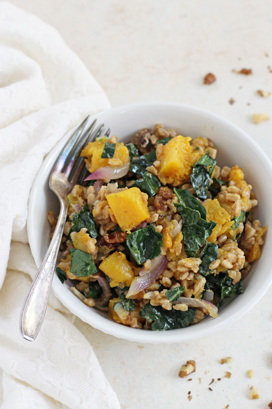 A small white bowl filled with Butternut Squash Farro and a silver fork.
