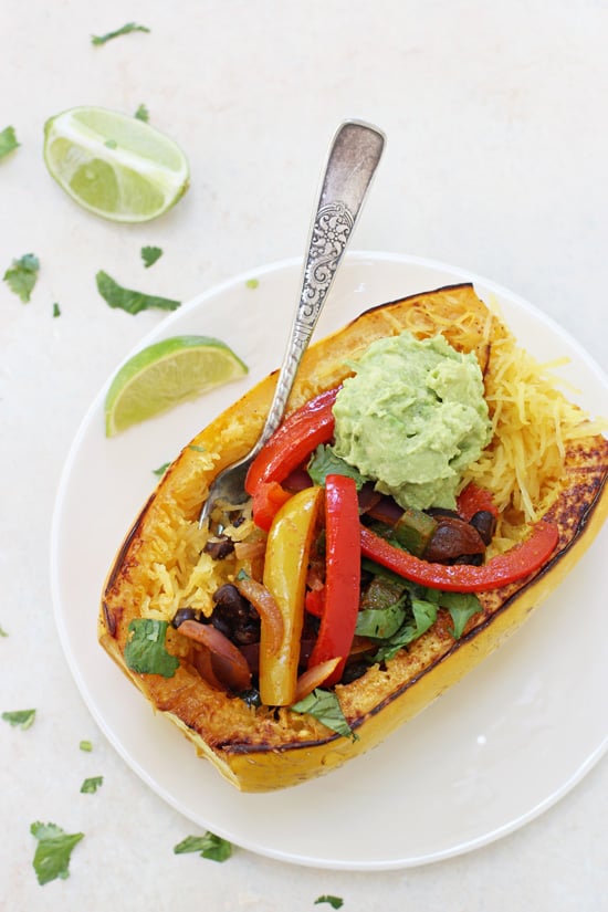 A Fajita Stuffed Spaghetti Squash on a white plate with a fork.