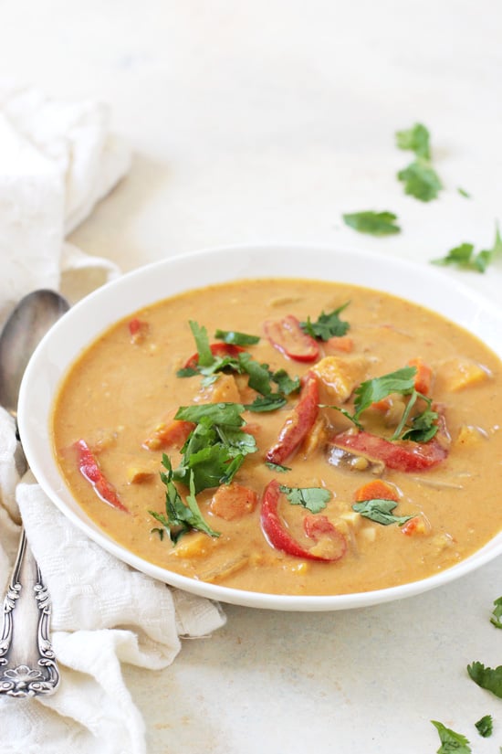 Thai Sweet Potato Soup in a white bowl with a silver spoon on the side.