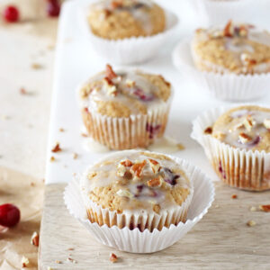 Soft and fluffy cranberry orange eggnog muffins! With whole wheat flour and sweetened with honey and maple syrup! Perfect for the season!