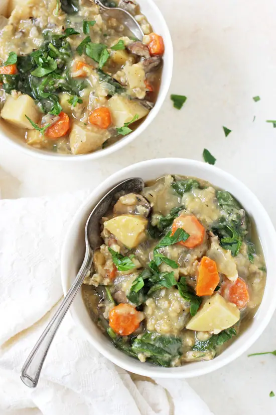 Two bowls of Slow Cooker Creamy Veggie & Wild Rice Soup with spoons in both bowls.