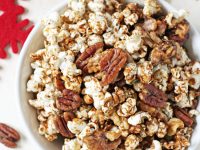 This easy sweet & spicy popcorn nut party mix is completely addicting! Made with fresh rosemary, warm spices and maple syrup!