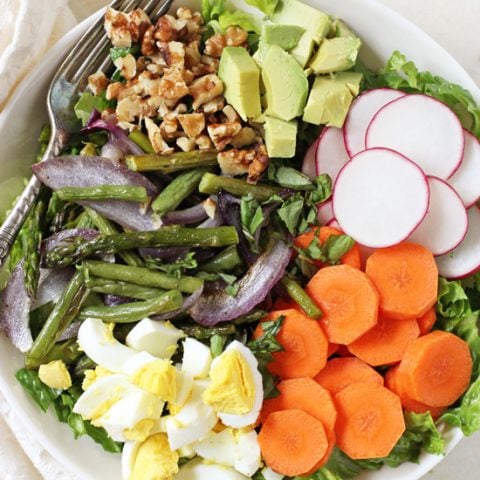 A colorful, crunchy and healthy spring vegetable cobb salad! With asparagus, green beans and a creamy basil dressing! On the table in 30 minutes!