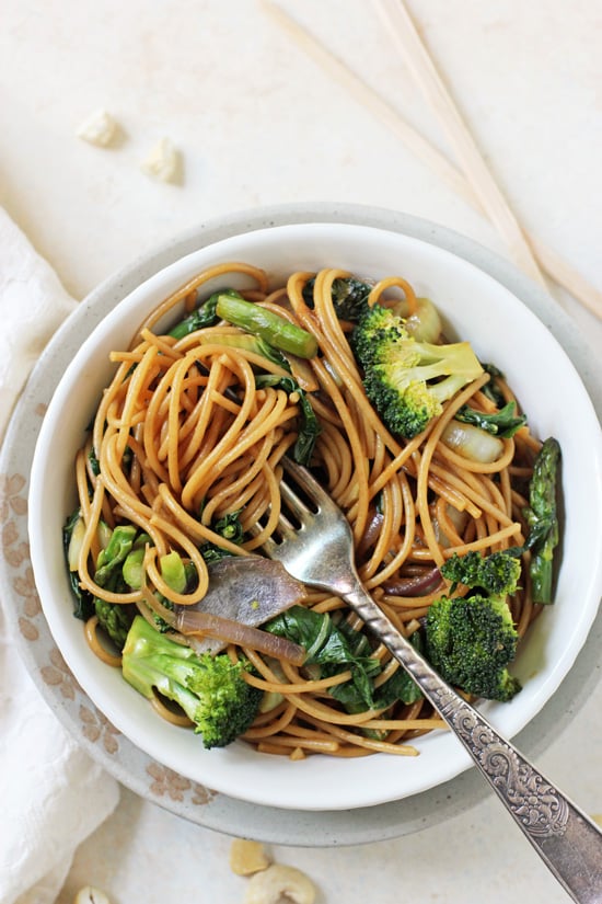 Spring Vegetable Lo Mein in a white bowl with a fork.