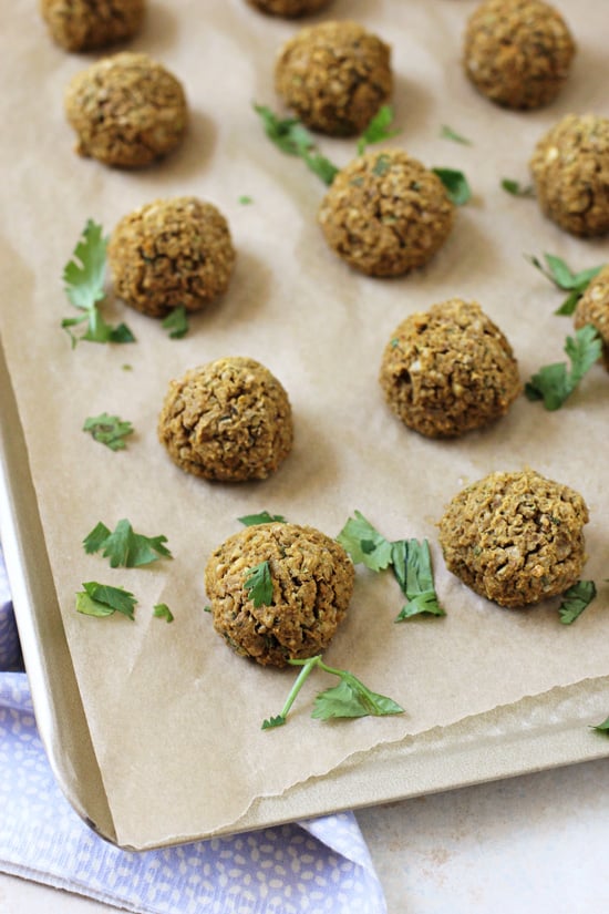 A baking sheet filled with Sweet Potato Falafel and a sprinkle of parsley.