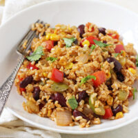 Quick and easy vegetable cajun brown rice! Cooks in one skillet! Packed with veggies, flavorful spices and kidney beans!