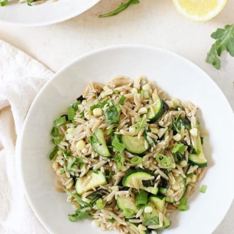 Zippy, light and fresh herbed zucchini and corn orzo salad! This simple pasta is perfect for barbecues or a quick and easy dinner!