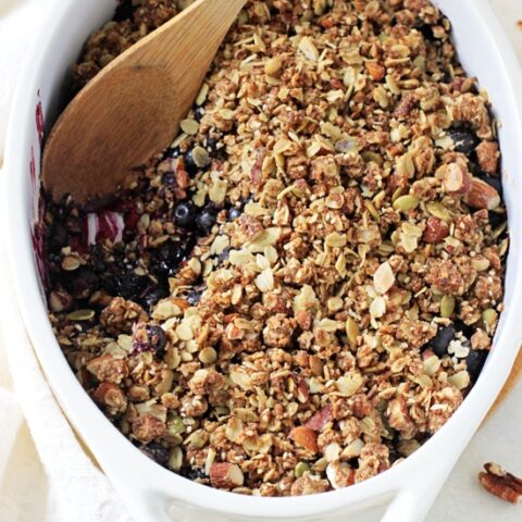 This easy blueberry breakfast crisp is a healthier spin on a classic dessert! Filled with juicy fresh berries and a granola-like topping!
