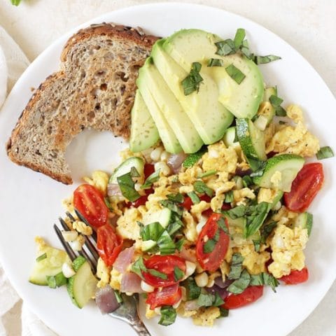 Simple, healthy and filling, this summer veggie egg scramble is perfect for breakfast or dinner! And it comes together in 25 minutes!
