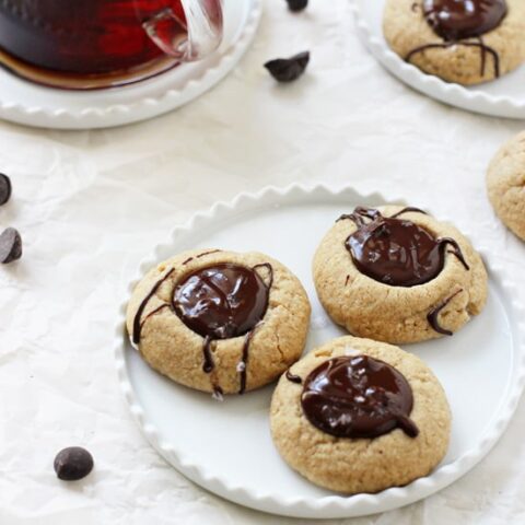 Irresistible chocolate peanut butter thumbprint cookies! With a soft peanut butter base, a chocolate peanut butter filling and a touch of flaky sea salt! Gluten-free & vegan!