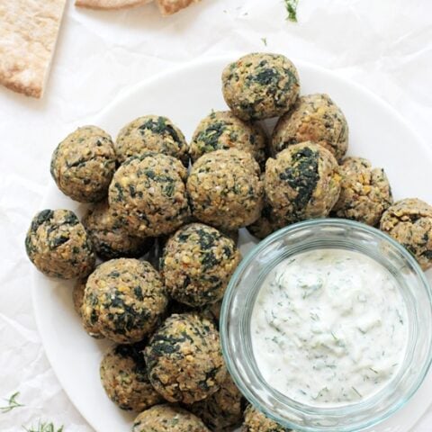 Baked greek vegetarian meatballs! Simple, healthy, protein packed and freezer friendly! Made with chickpeas, walnuts, spinach and sun-dried tomatoes!