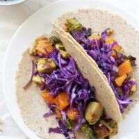 Easy roasted winter vegetable tacos! With butternut squash, brussels sprouts and an irresistible honey mustard sauce! Quick, wholesome, delicious!