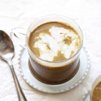 This easy and healthy chocolate golden milk is a perfect bedtime treat! With warm almond milk, cocoa powder, spices and topped with whipped coconut cream!
