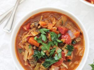 Easy vegetarian stuffed cabbage soup! This simple dish is cozy, warming and healthy! Packed with carrots, mushrooms, lentils and cabbage! Vegan & gluten free!