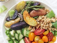 Easy greek salad with roasted vegetables! This healthy dish is packed with fingerling potatoes, green beans, fresh veggies and a flavorful vinaigrette! Serve as a side or as a main topped with a protein of choice!