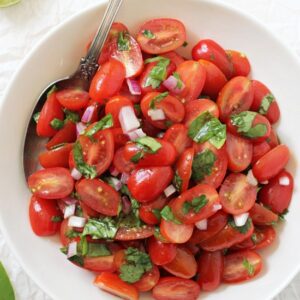 This healthy & easy fresh cherry tomato salsa is a summer staple! Serve with chips, in your favorite tacos or spooned over eggs! And just 15 minutes or less to make!
