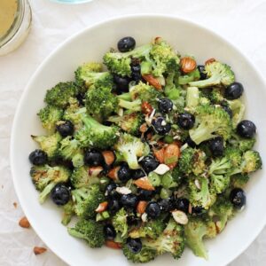 This simple roasted broccoli salad is healthy, fresh and a fun twist on the classic dish! Filled with blueberries, almonds and a maple mustard dressing! Vegan, gluten free, and no mayo in sight!
