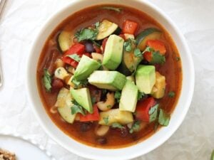 Easy & flavorful homemade mexican minestrone soup! This healthy dinner is packed with zucchini, bell pepper, black beans & spices! Vegan and easily made gluten free!