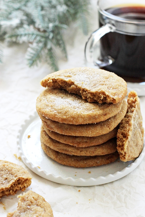 A side angle photo of a stack of Soft & Chewy Cardamom Spice Cookies with one cookie split in half.