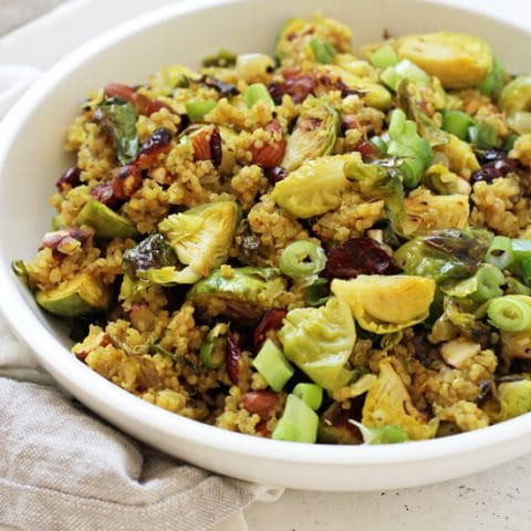 Healthy cranberry quinoa salad with brussels sprouts! Filled with crunchy almonds, dried cranberries and warm spices, it’s perfect for make-ahead meals or sides! Vegan & gluten free!