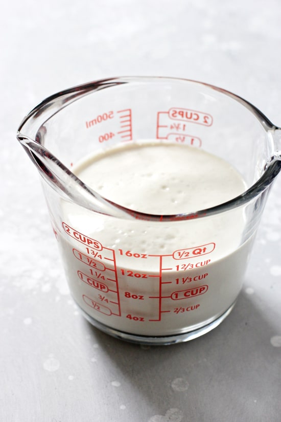 Dairy free cashew heavy cream in a large glass measuring cup.