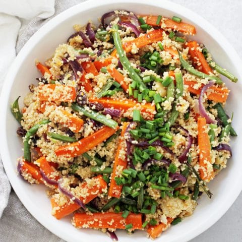 This easy vegan couscous salad is filled with roasted veggies, crunchy walnuts, raisins and a simple maple orange dressing! A perfect light & healthy meal or side! Excellent for make-ahead lunches or dinners!