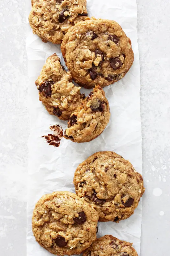 A row of Coconut Oil Cookies on a piece of white parchment paper.