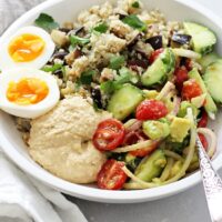 Fast, fresh and simple, these mediterranean hummus bowls are a perfect weeknight meal! With cauliflower rice, fresh tomatoes + cucumber, creamy hummus and soft boiled eggs! They’re healthy and excellent for meal prep! Gluten and dairy free!