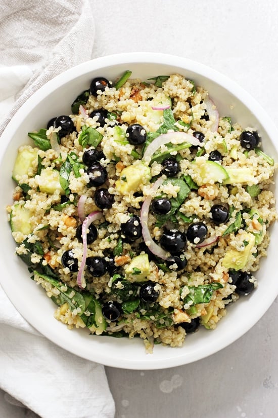 A white bowl filled with Blueberry Quinoa with a napkin to the side.
