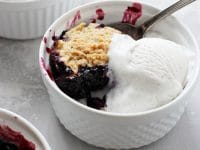 With juicy blueberries and a buttery coconut oil biscuit topping, this easy homemade vegan blueberry cobbler is the perfect summer dessert! And made even better with a scoop of your favorite vegan ice cream or whipped coconut cream! Includes option to use frozen berries.