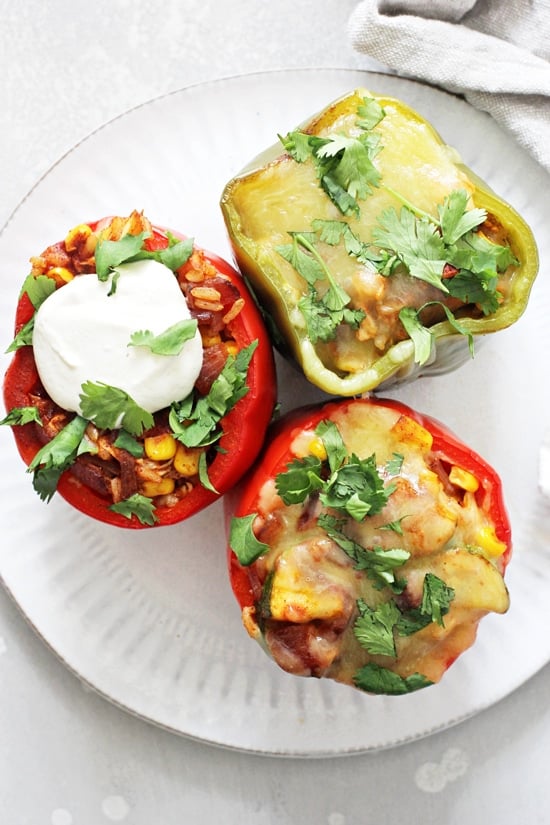 A white plate with three Enchilada Stuffed Peppers.