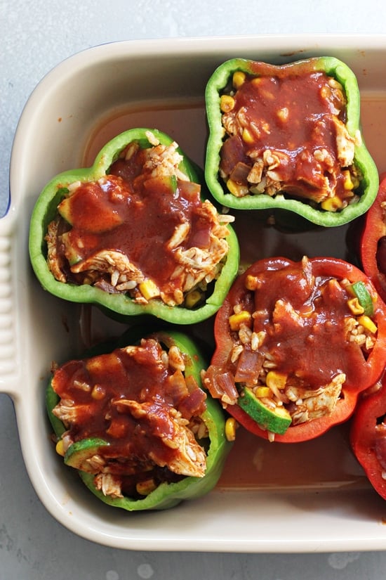 A baking dish with unbaked Mexican Stuffed Peppers.
