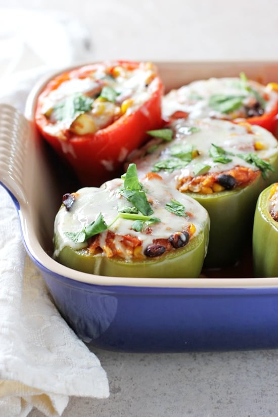 A purple baking dish with Vegetarian Mexican Stuffed Peppers.