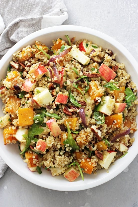 A white bowl filled with Fall Quinoa Salad.