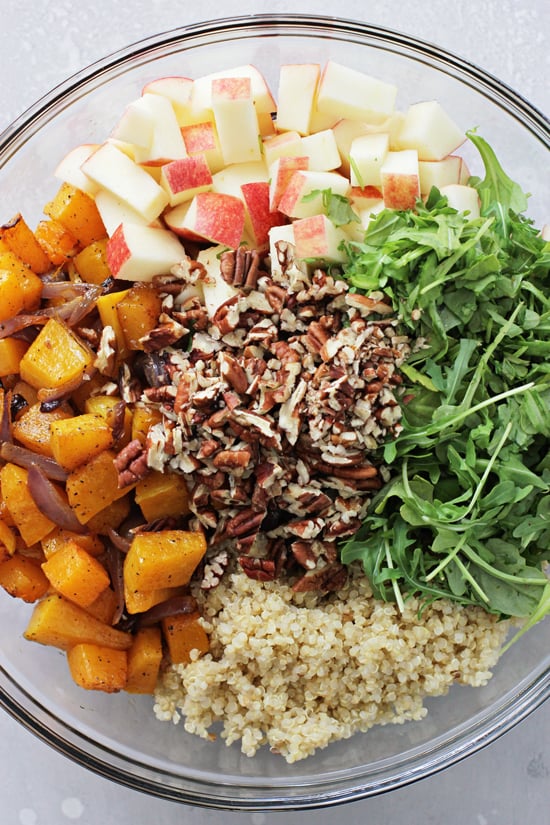 All the components for Butternut Squash Quinoa Salad in a mixing bowl.