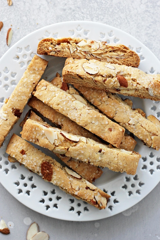 A white plate filled with Vanilla Almond Vegan Biscotti.