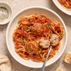 Dairy Free Meatballs in a white bowl with spaghetti.
